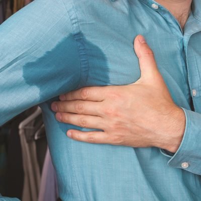 Sweaty armpit and a wet spot on his shirt because of the heat